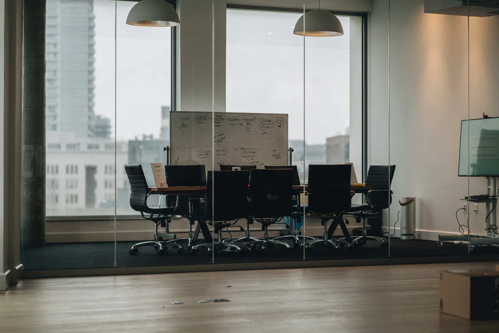 Quiet conference room overlooking a city, representing post-acquisition integration planning.