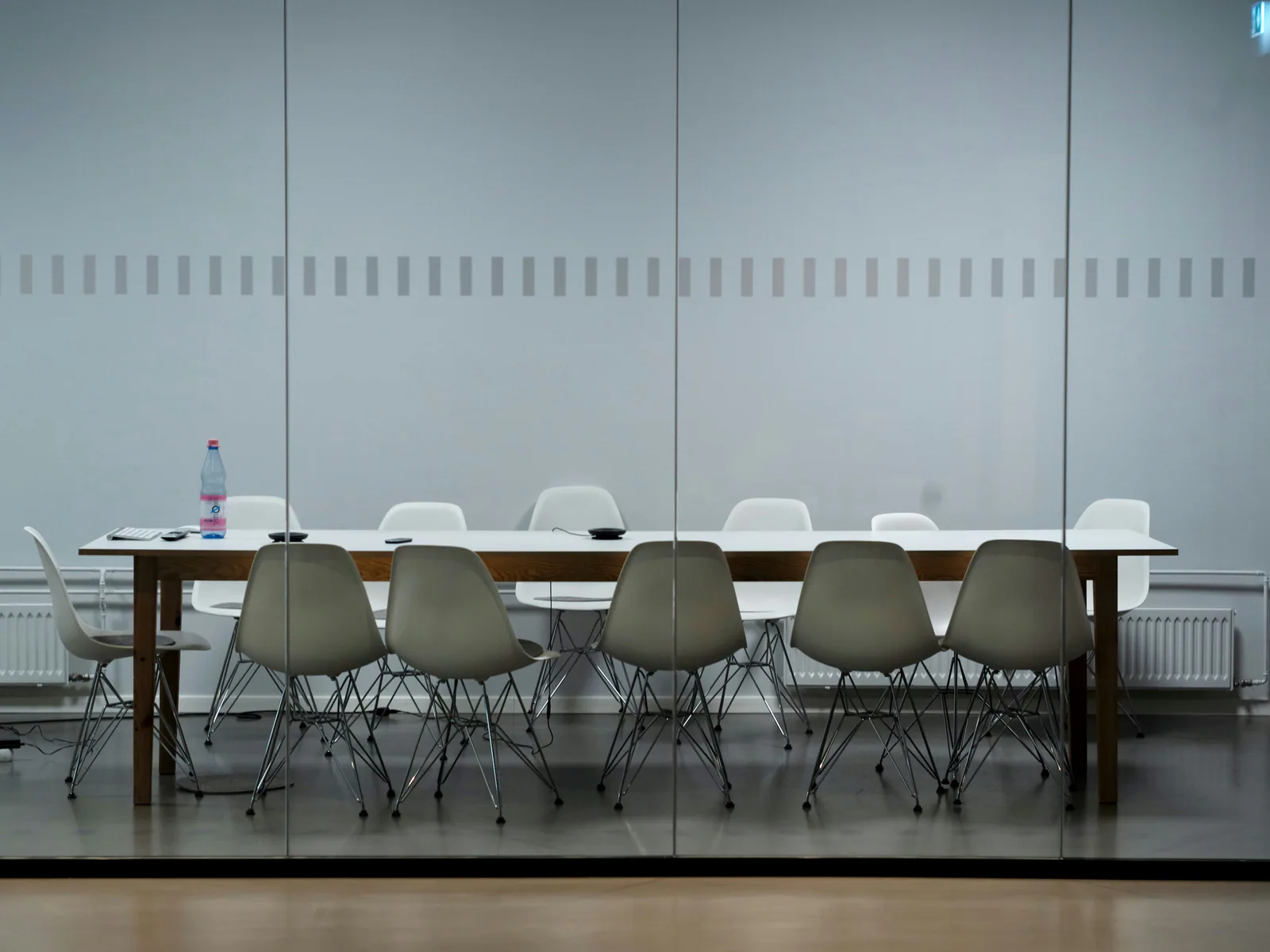 Empty meeting table in a bright room, representing behavioral risk signals in cross-border M&A.