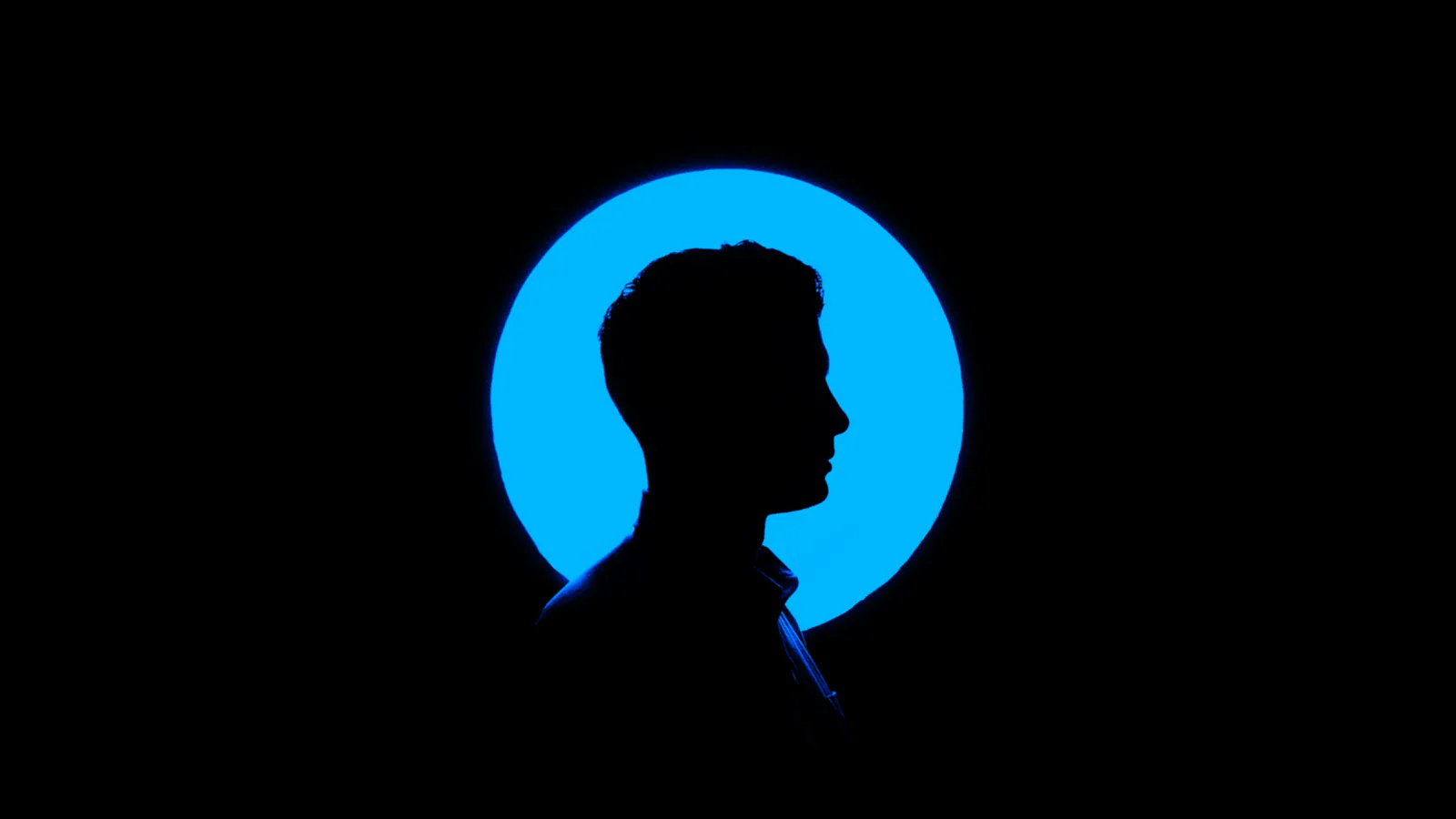 Silhouetted executive profile against blue light, representing CHRO leadership readiness decisions.