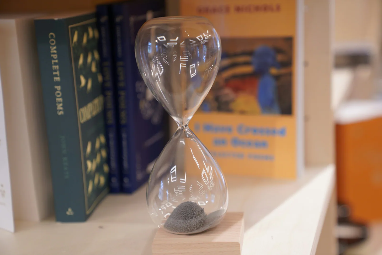 Hourglass on a bookshelf, representing cultural due diligence timing in US-India deals.