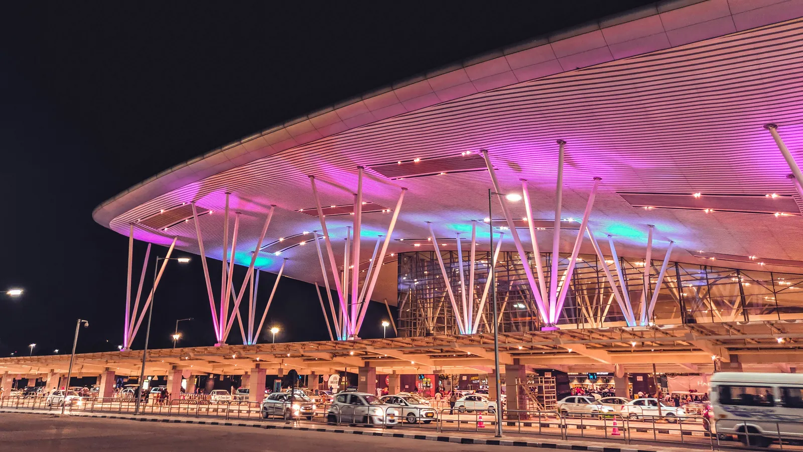 Illuminated airport hub at night, representing global mobility and operating rhythm.