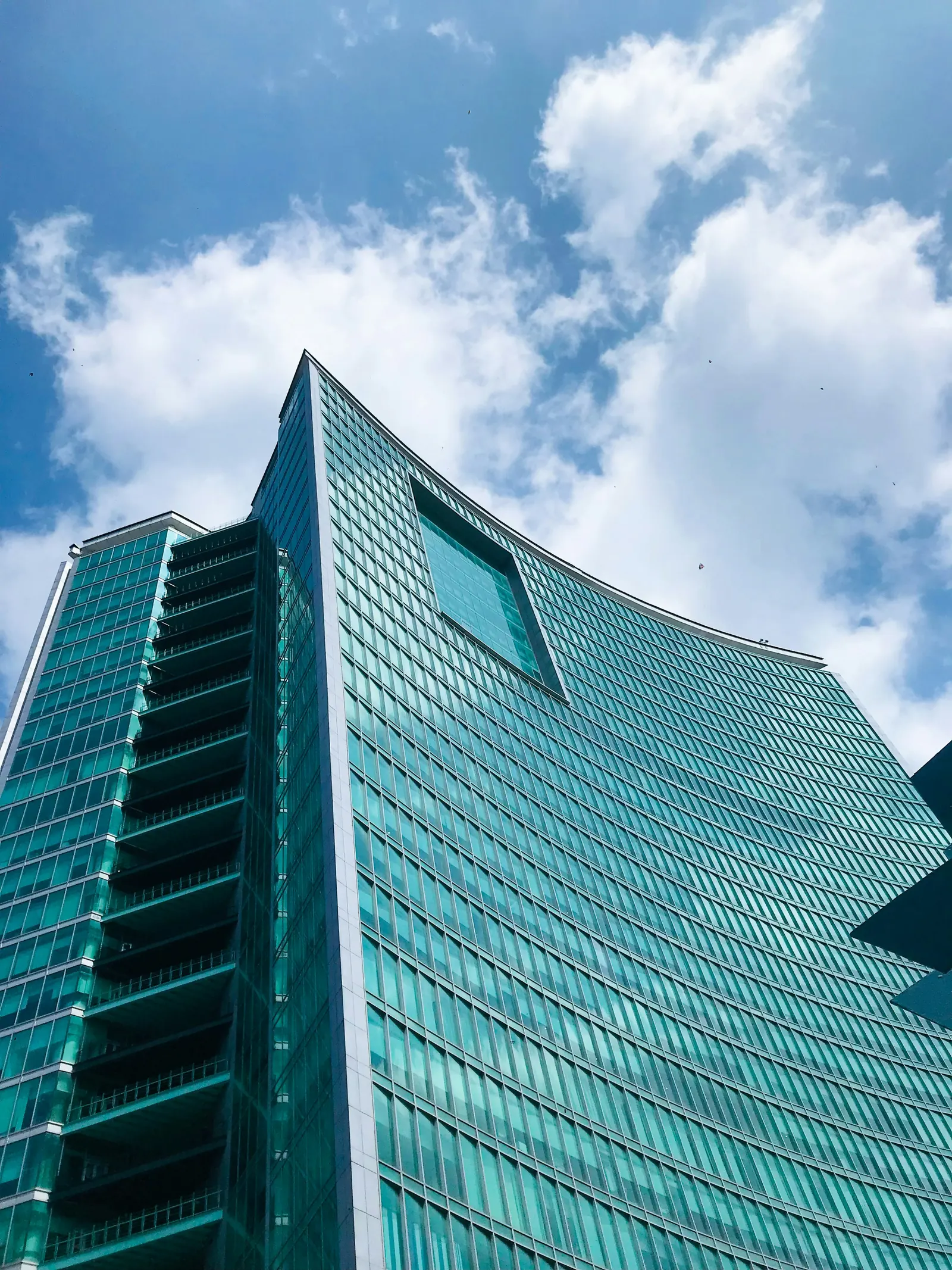 Modern Bangalore office tower seen from below, representing India-based leadership capability.