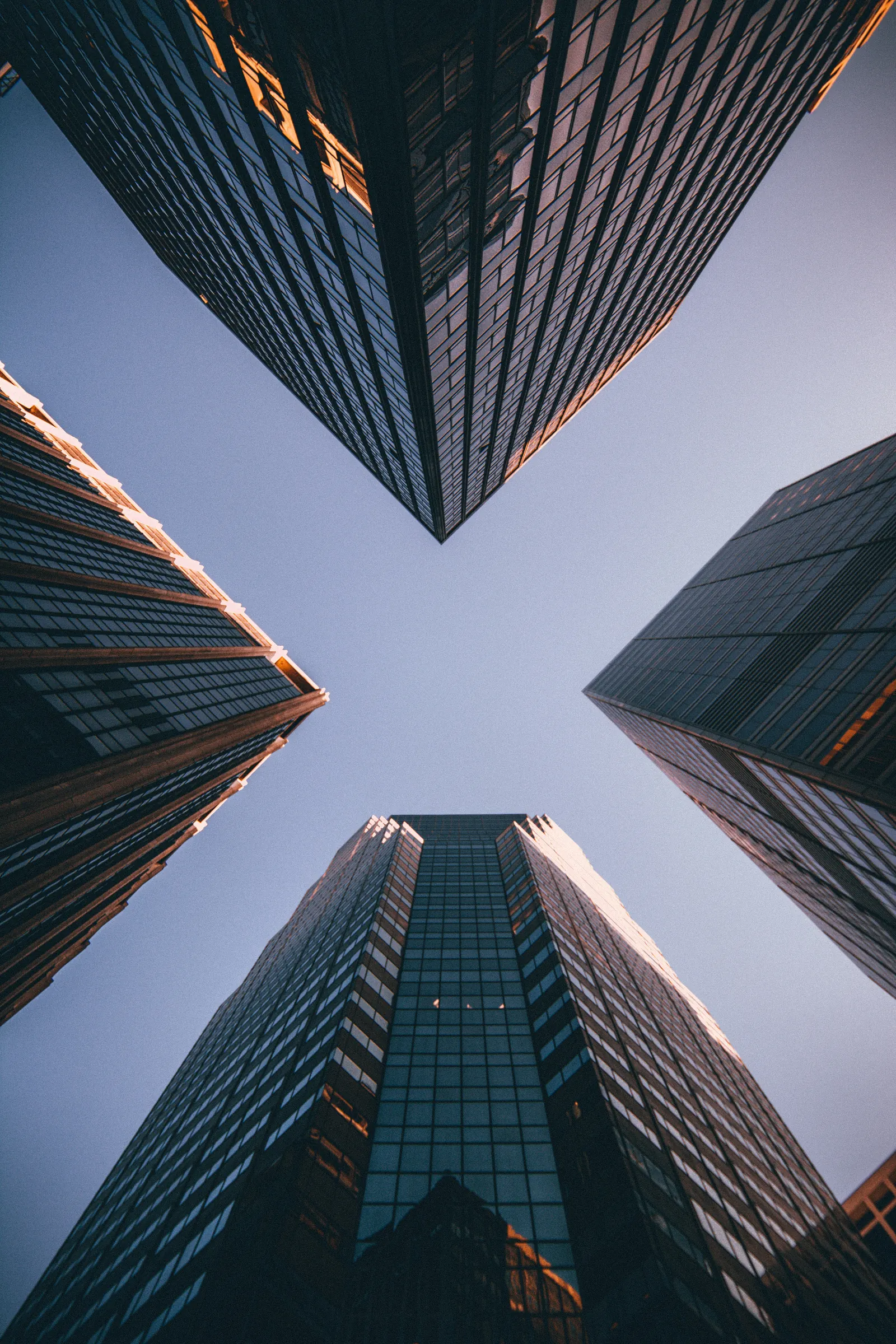 Tall buildings seen from below, representing culture as execution infrastructure.