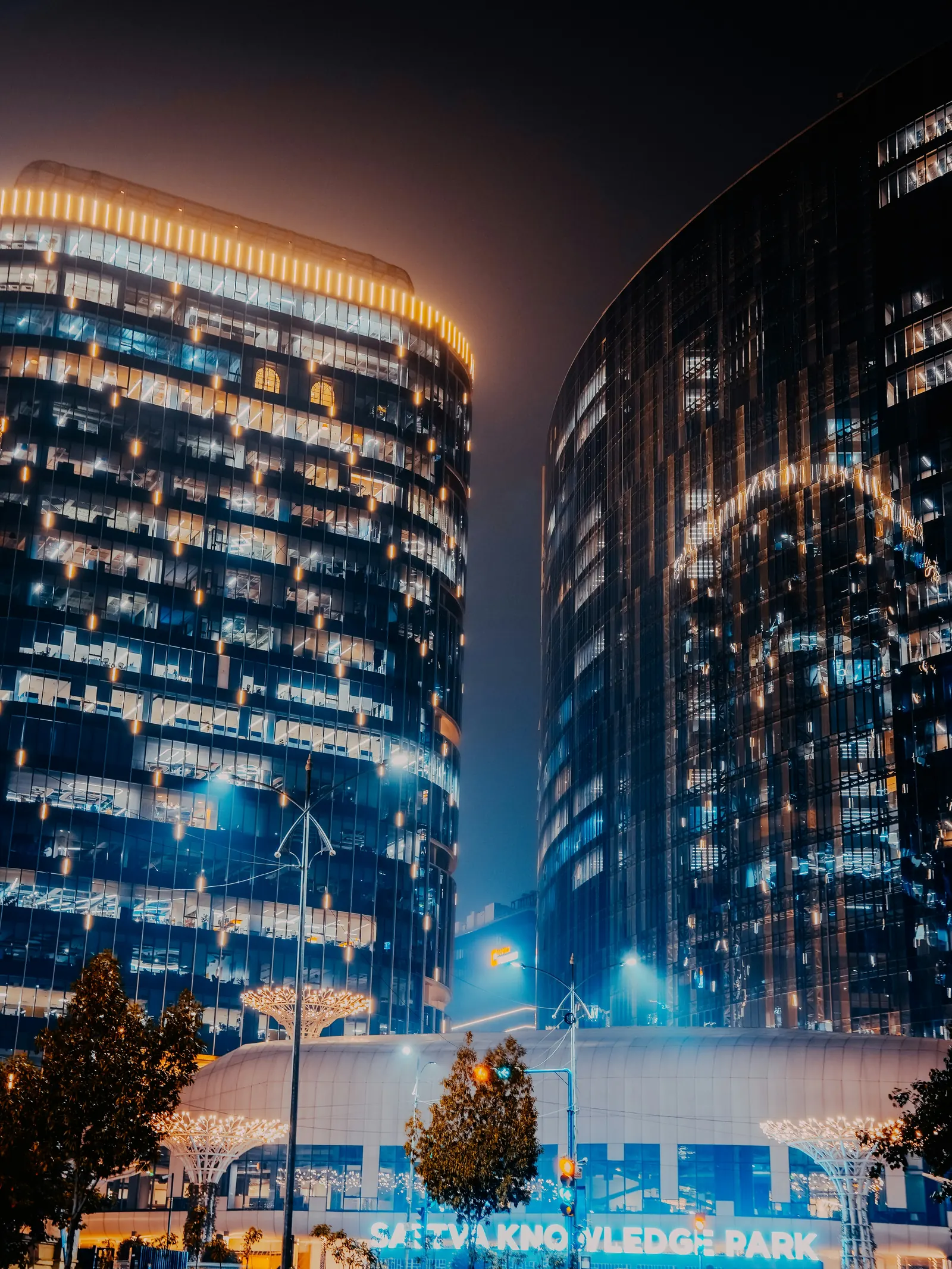 Illuminated Hyderabad business towers, representing India GCC scale and enterprise growth.