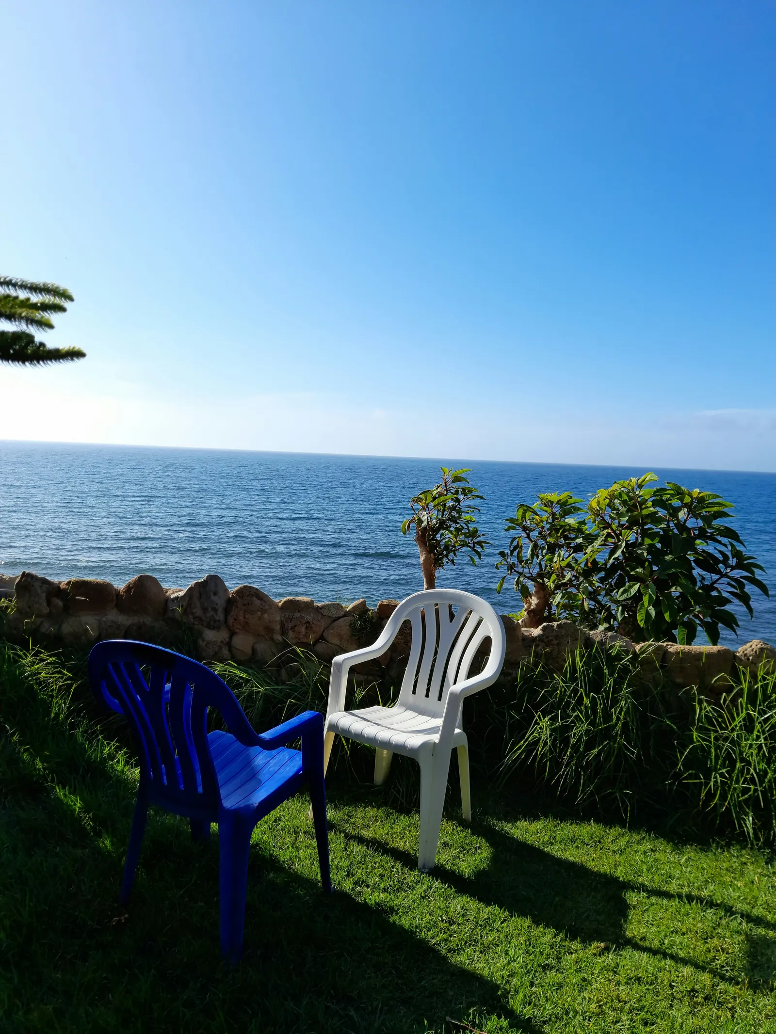 Two chairs facing the ocean, representing quiet negotiation and leadership conversation.