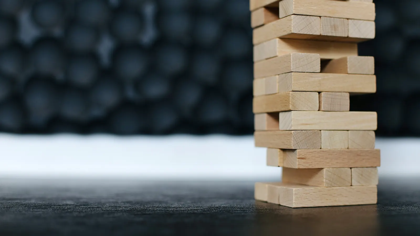 Stacked wooden blocks, representing integration risk and stability.